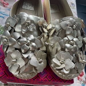 Tory Burch gold Blossom espadrilles.